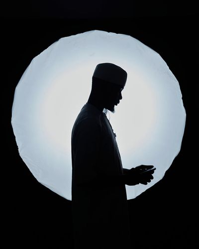 Silhouette of a man in a meditative stance, suggesting inner peace.